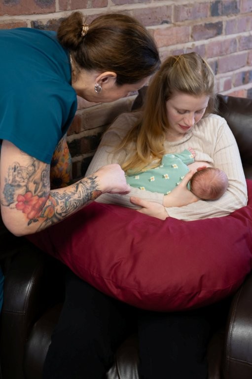 Sharon watching a mother breastfeed her new baby