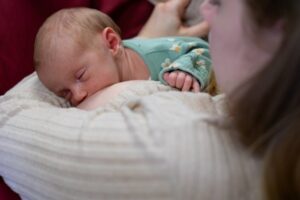 A very young baby breastfeeding with her mother