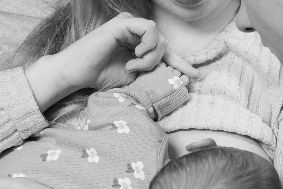 Sharon helping a mum to latch the baby during a breastfeeding assessment