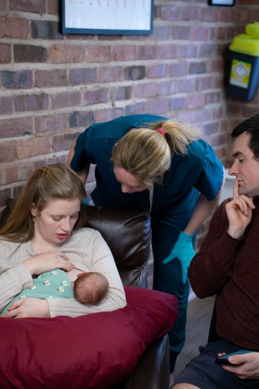 Laura watching a newborn baby breastfeed to see the signs of tongue-tie